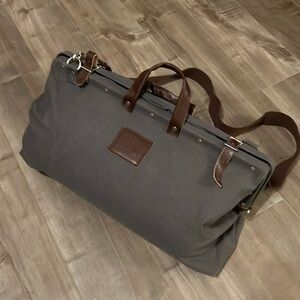 Line of Trade. Weekender Bag. Durable canvass w/carry strap and leather accents.